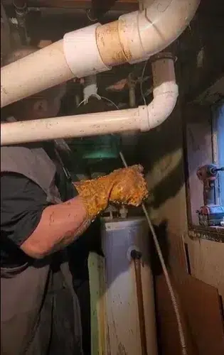Technician fixing leak in Elk Grove