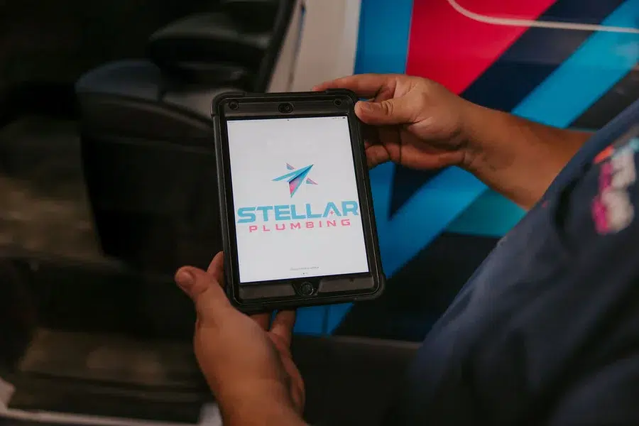 tablet shown in a stellar plumbing van held by technician about to perform arlington heights sump pump services