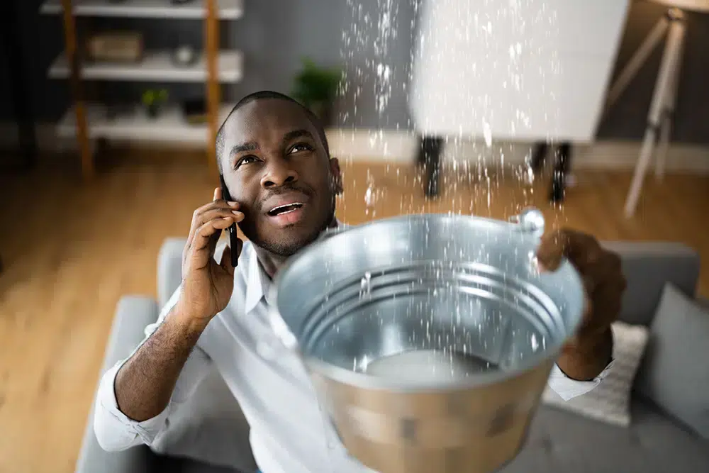 Man on the phone with leaking ceiling