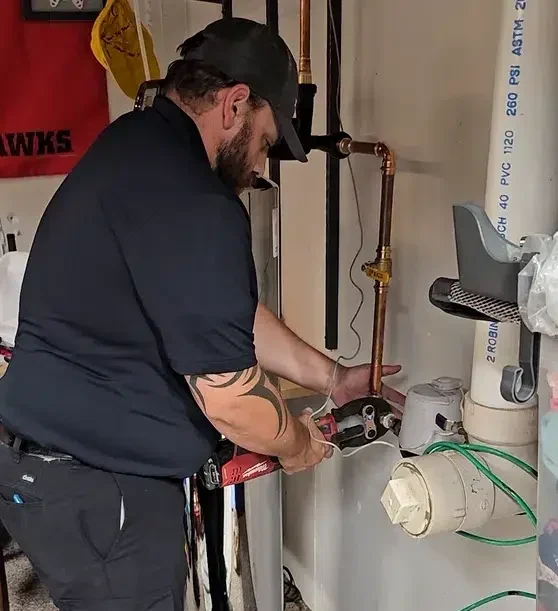 Technician working on leaking pipe in Elk Grove, IL.