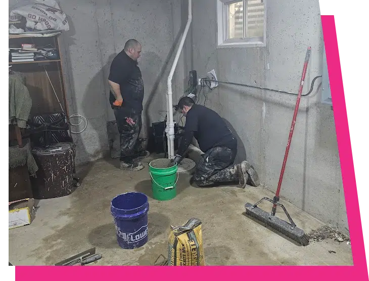 Two Stellar Plumbing technicians installing a sump pump and drain line in a basement in Elk Grove Village, IL