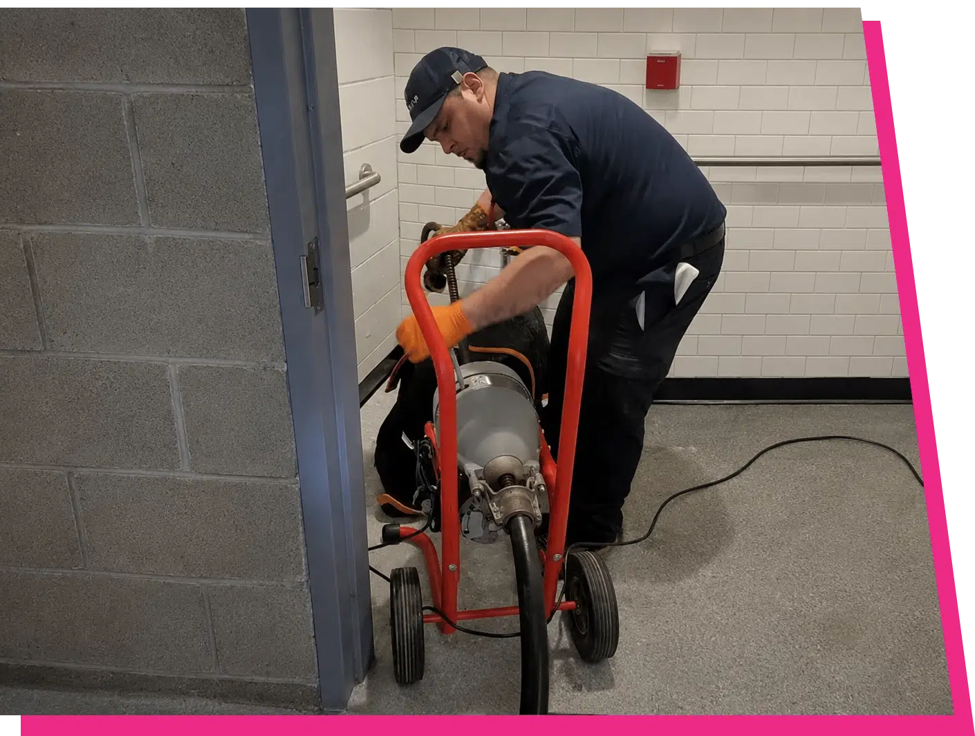 Stellar Plumbing technician using a drain snake machine to clear a clogged toilet in Des Plaines