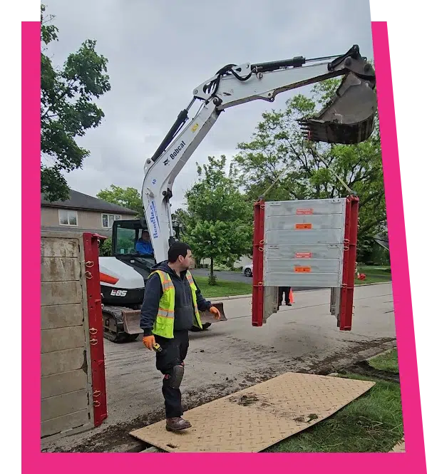 Stellar Plumbing crew using a Bobcat excavator for sewer line replacement on a residential street in Elk Grove Village, IL